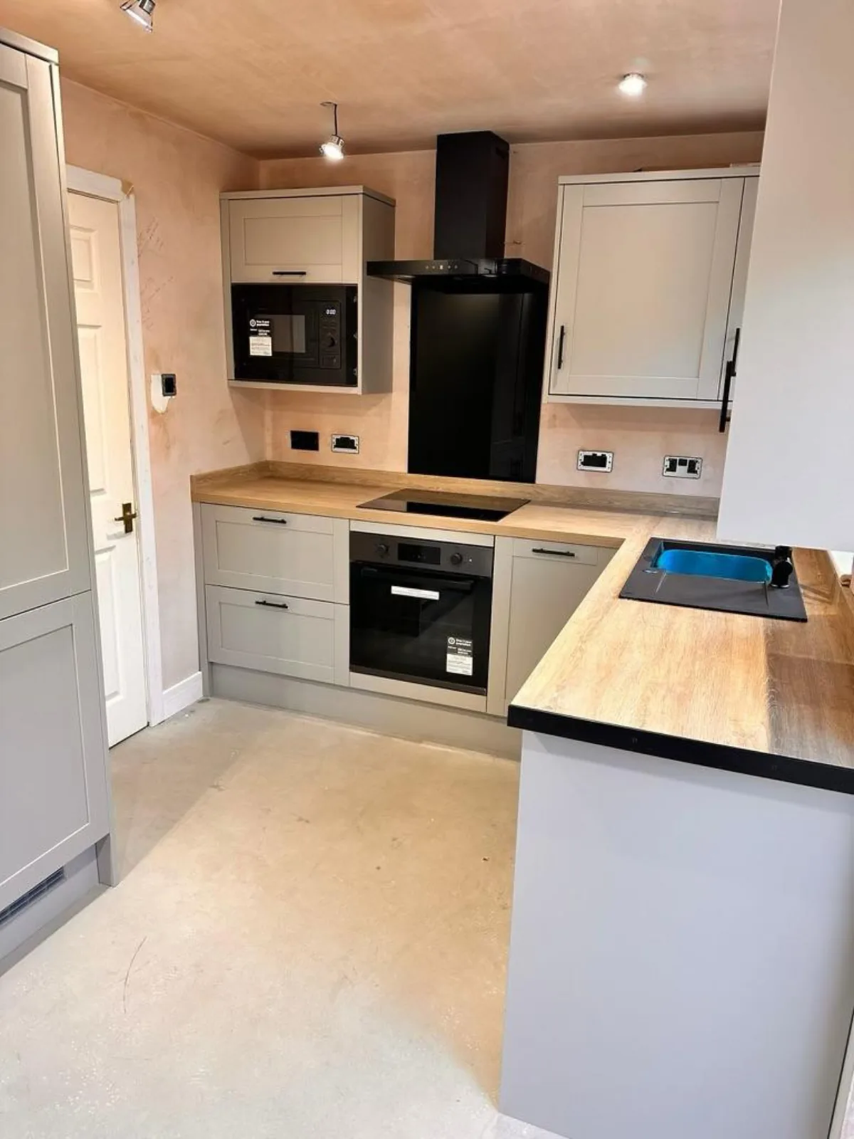 New grey kitchen units fitted during a refurbishment